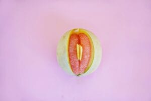 Artistic image of a grapefruit with a pink backdrop. Abstract and conceptual.