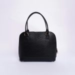 Stylish black handbag showcased against a minimalist white backdrop in studio setting.